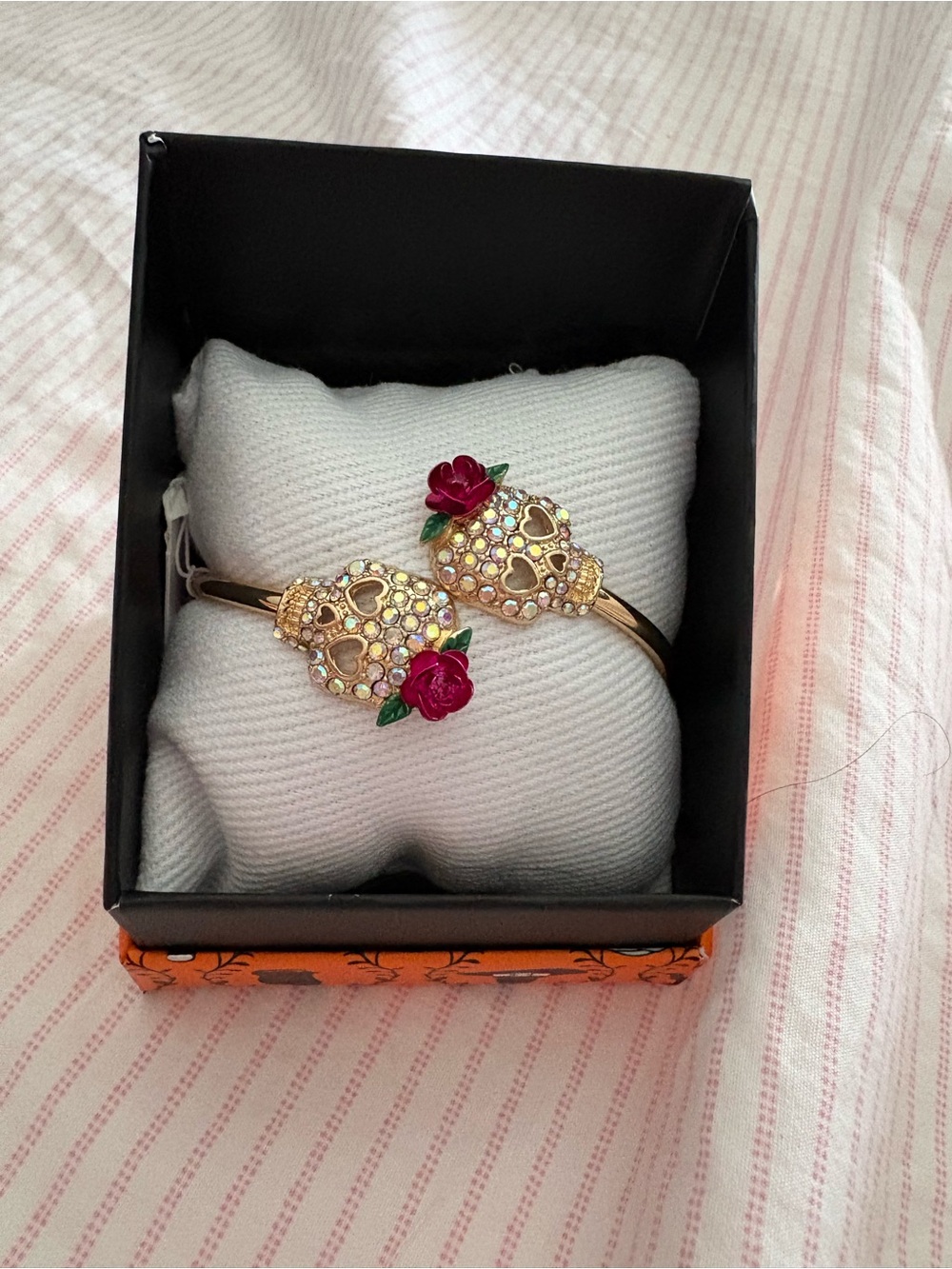 Gold-Tone Crystal Skull Bangle Bracelet with Red Rose Accents